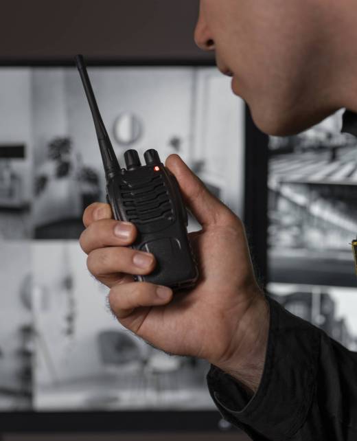 portrait-male-security-guard-with-radio-station-camera-screens (1)